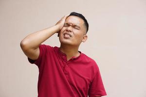 Asian man has a headache stress from work photo