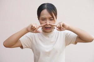 Asian woman having stuffy nose from cold photo