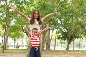 Mother and baby playing in the park happily. photo