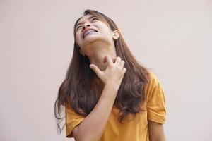 Asian woman having an itchy throat photo