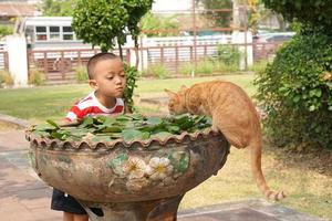 Boy playing with cat in the bath photo