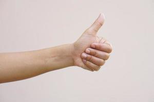 Asian woman raising hand showing great sign photo