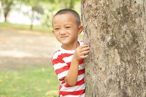 concept of saving the world boy hugging a tree photo