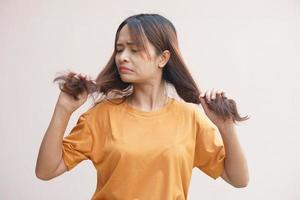 Asian women have damaged hair, dandruff and split ends. photo