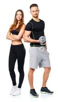 Athletic man and woman with dumbbells on the white photo