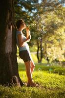 A girl blows bubbles photo