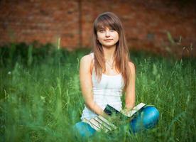 Beautiful girl with book in the park photo