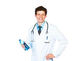 Portrait of a smiling male doctor holding bottle of water on white photo