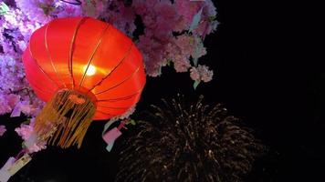 Firework display at the background of red lantern hanging video