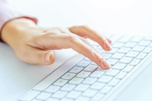 Woman office worker typing on the keyboard photo