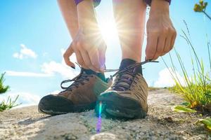 Hiking shoes - woman tying shoe laces photo