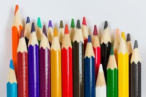 Colored pencils on white background photo