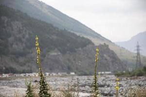 Mountain river against the backdrop of beautiful mountains and sky. photo