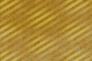 Golden holiday background. Gold stripes with sequins. photo