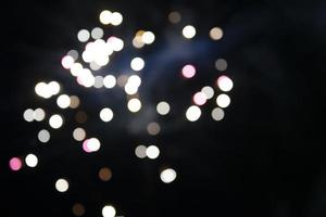 On a black background bokeh from explosions of colorful fireworks. photo