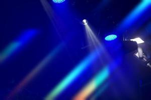 Stage colored optical light from a spotlight on a dark blue background. photo