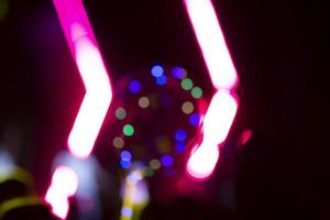 Bright pink stripes of optical bokeh on a dark background. photo