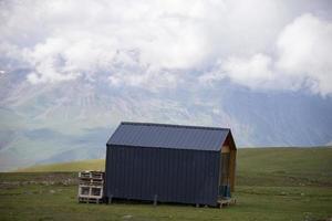 In a mountainous area there is a lonely ecological modern house. photo