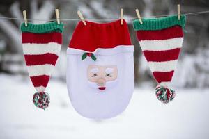 Santa's Christmas bag and striped hats are dried on a rope. Preparing to celebrate Christmas. photo