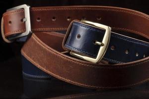 Leather belts on a black background. Haberdashery. photo