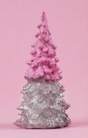 Christmas composition. Pink and silver Christmas tree on a pink background. Happy Holidays. minimal new year concept. photo