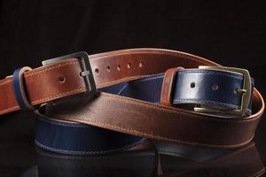 Leather belts on a black background. Haberdashery. photo