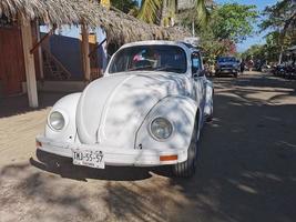 Puerto Escondido Oaxaca Mexico 2023 Colorful tuned old classic vintage car cars Puerto Escondido Mexico. photo