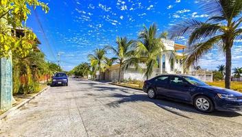 Puerto Escondido Oaxaca Mexico 2023 Colorful street with houses palms cars restaurants Puerto Escondido Mexico. photo