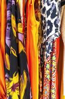 Colorful women clothes and dresses on hangers in closet Mexico. photo