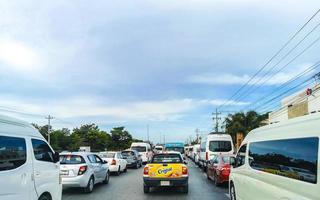 Playa del Carmen Quintana Roo Mexico 2022 Driving traffic jam on road street highway through jungle nature. photo