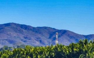 Mountain panorama cliffs rocks hilly tropical landscape Puerto Escondido Mexico. photo