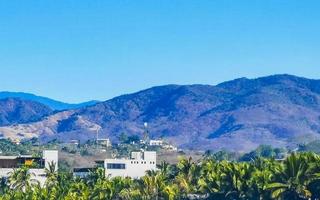 Mountain panorama cliffs rocks hilly tropical landscape Puerto Escondido Mexico. photo