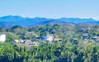 Mountain panorama cliffs rocks hilly tropical landscape Puerto Escondido Mexico. photo