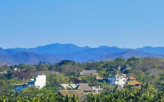 Mountain panorama cliffs rocks hilly tropical landscape Puerto Escondido Mexico. photo