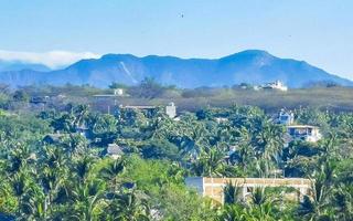 Mountain panorama cliffs rocks hilly tropical landscape Puerto Escondido Mexico. photo