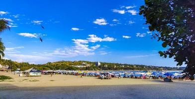 Fishing boats at the harbor beach in Puerto Escondido Mexico. photo