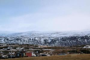 Icelandic landscape with snow covered mountains and clouds in winter. photo