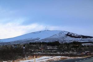 Icelandic landscape with snow covered mountains and clouds in winter. photo