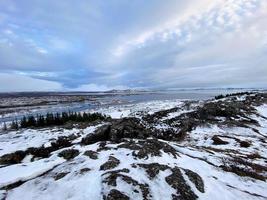 Icelandic landscape with fjord, lake and mountains in winter at Pingvellir National Park photo