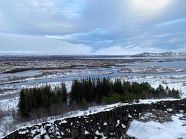 Icelandic landscape with fjord, lake and mountains in winter at Pingvellir National Park photo