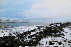 Icelandic landscape with fjord, lake and mountains in winter at Pingvellir National Park photo