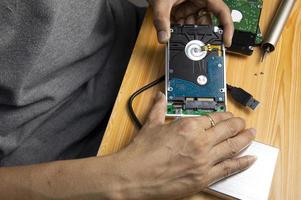 top view, man assembling an external hard drive photo