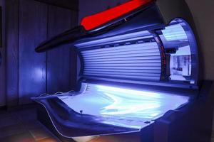 Empty modern tanning bed in room of luxury hotel photo