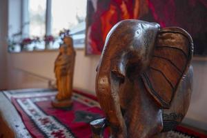 Wooden elephant figurine kept on table in luxury hotel room photo