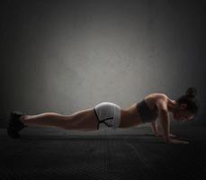 Woman doing push-ups photo