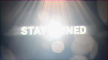 Stay Tuned golden text optical flares light video