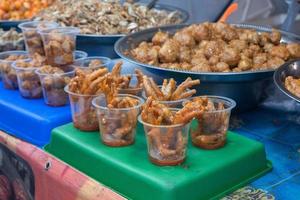 stir-fried chicken legs with chili sauce, in Indonesian it is called stir-fried chicken feet. served in plastic cups for sale at culinary festivals photo