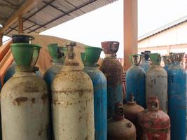 various types of gas cylinder bottles, acetyline, oxygen and argon. Incorrect storage can cause an explosion in the workplace photo