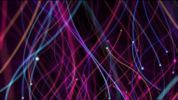 Vibrant multi-colored glowing, flowing colorful particles and motion trails. HD and looping abstract motion background animation. video