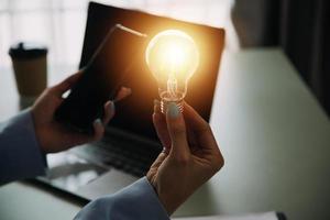 woman Hand holding Light bulb Global Internet connection. Business global internet connection application technology and digital marketing, Financial and banking, Digital link tech, big data. photo